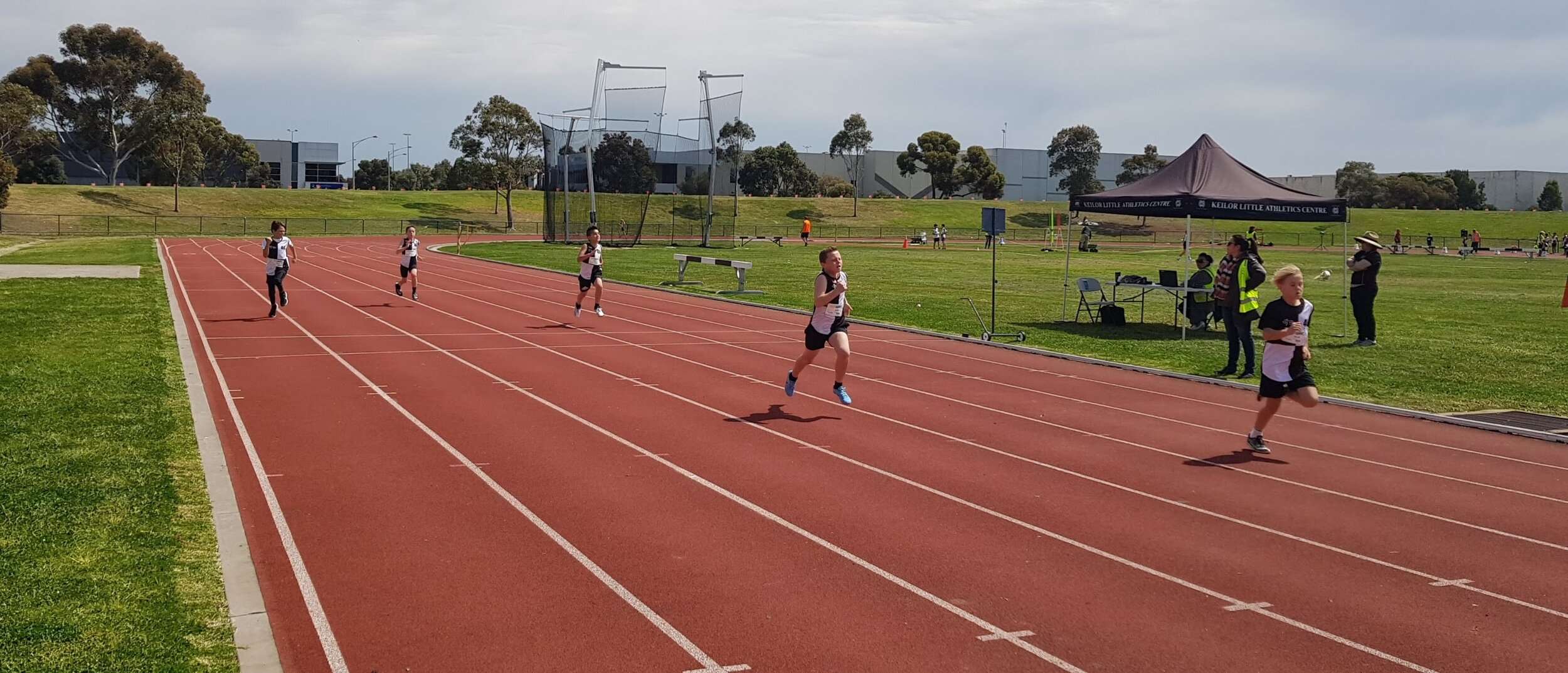 An athletics track with children running on it