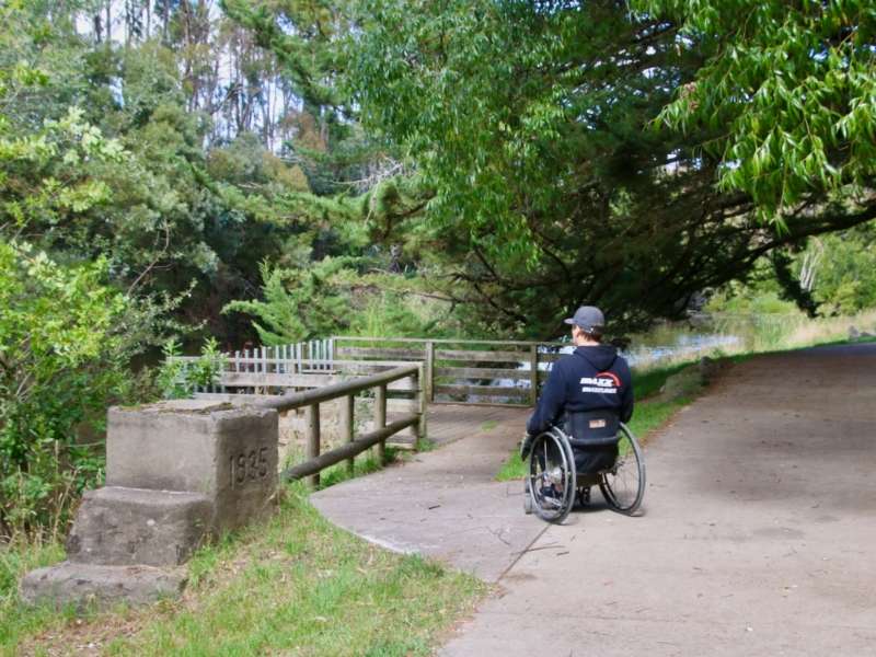 A wheelchair user on Campaspe River Accessible Walk