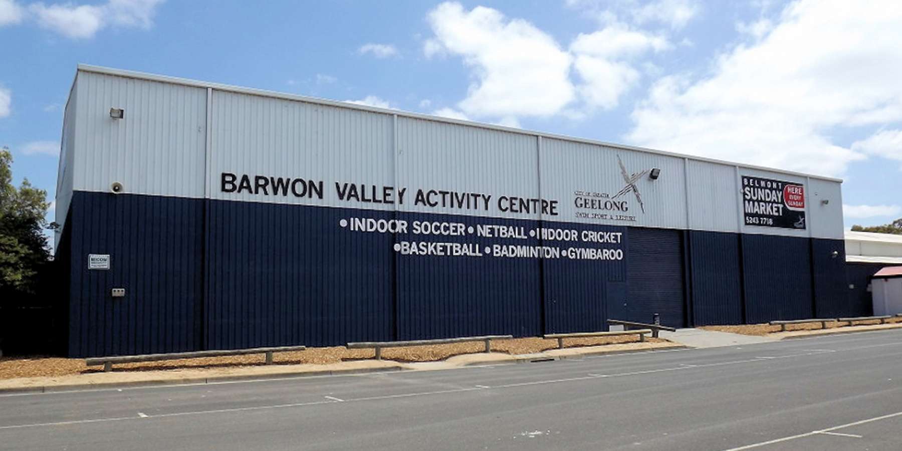 Exterior view of the Barwon Valley Activity Centre, featuring signage for sports and community activities against a clear blue sky.