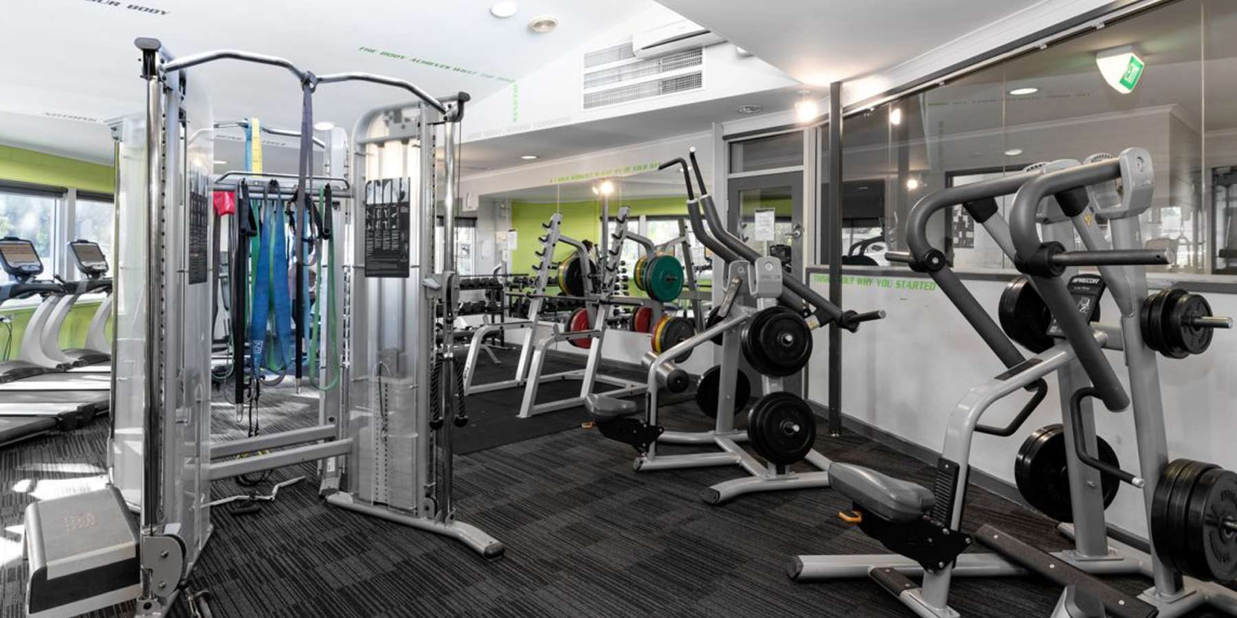 A modern gym featuring various fitness equipment, including weight machines and cardio machines, with bright, well-lit interiors.Diamond Creek Community Centre Gym
