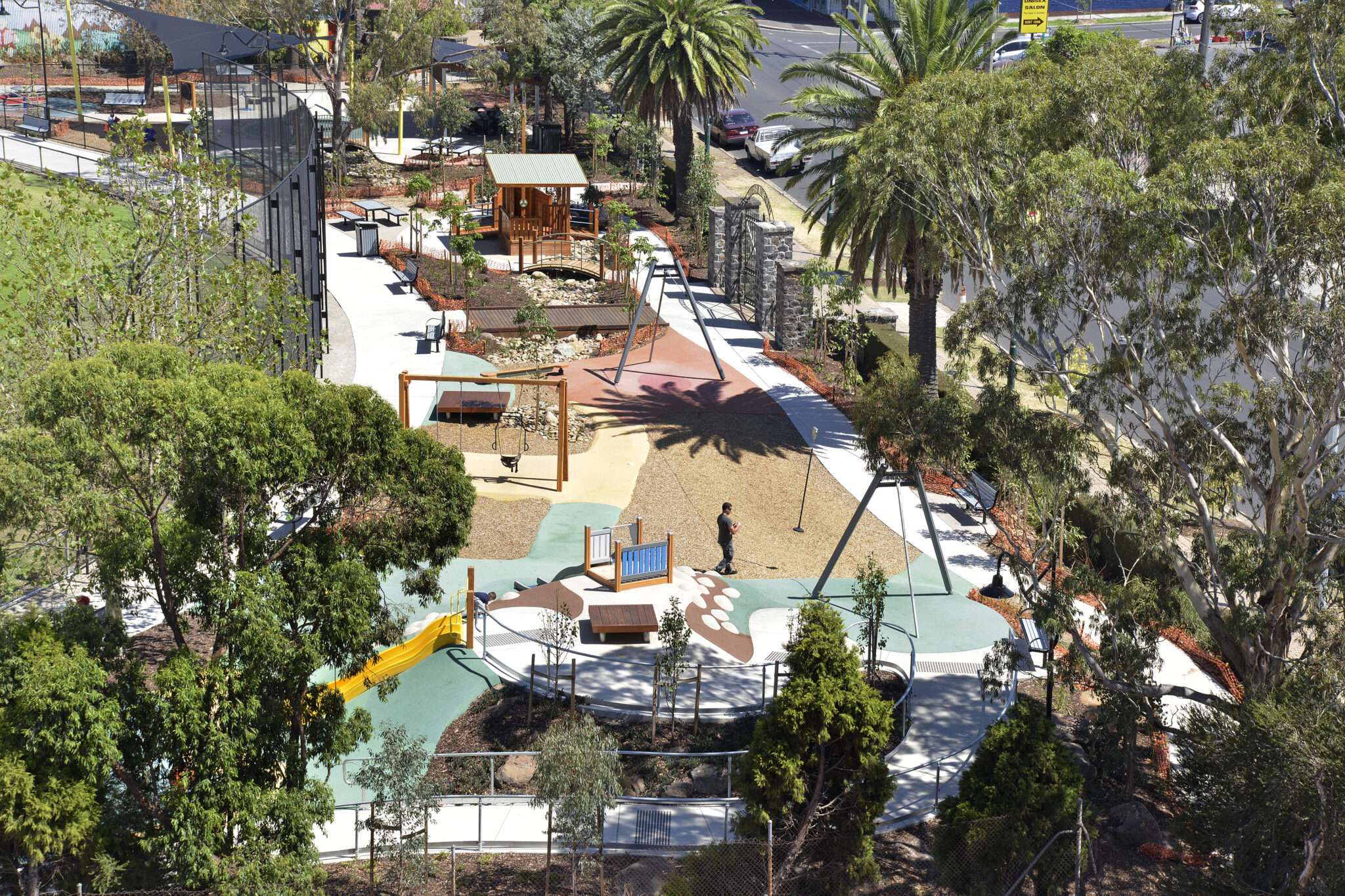 A large playground next to a large oval.