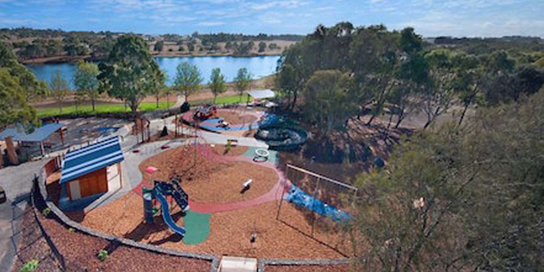 arial image of a playscape with a lake in the background