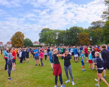 Image of a group of people standing together in a green space