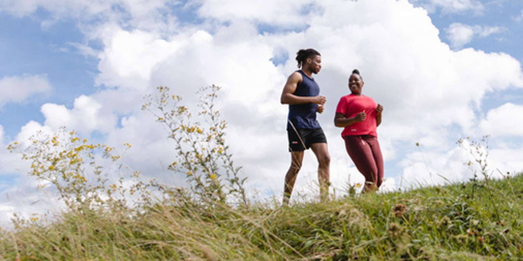 Two people running in an open space