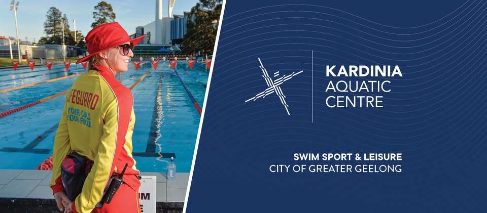 An indoor inground level swimming pool with multiple lanes divided by ropes.