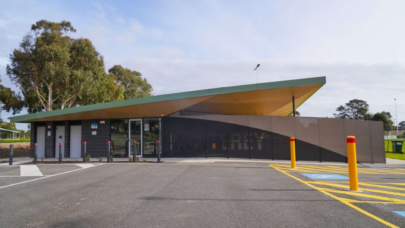 A large rectangular building with angled roof and accessible car parks