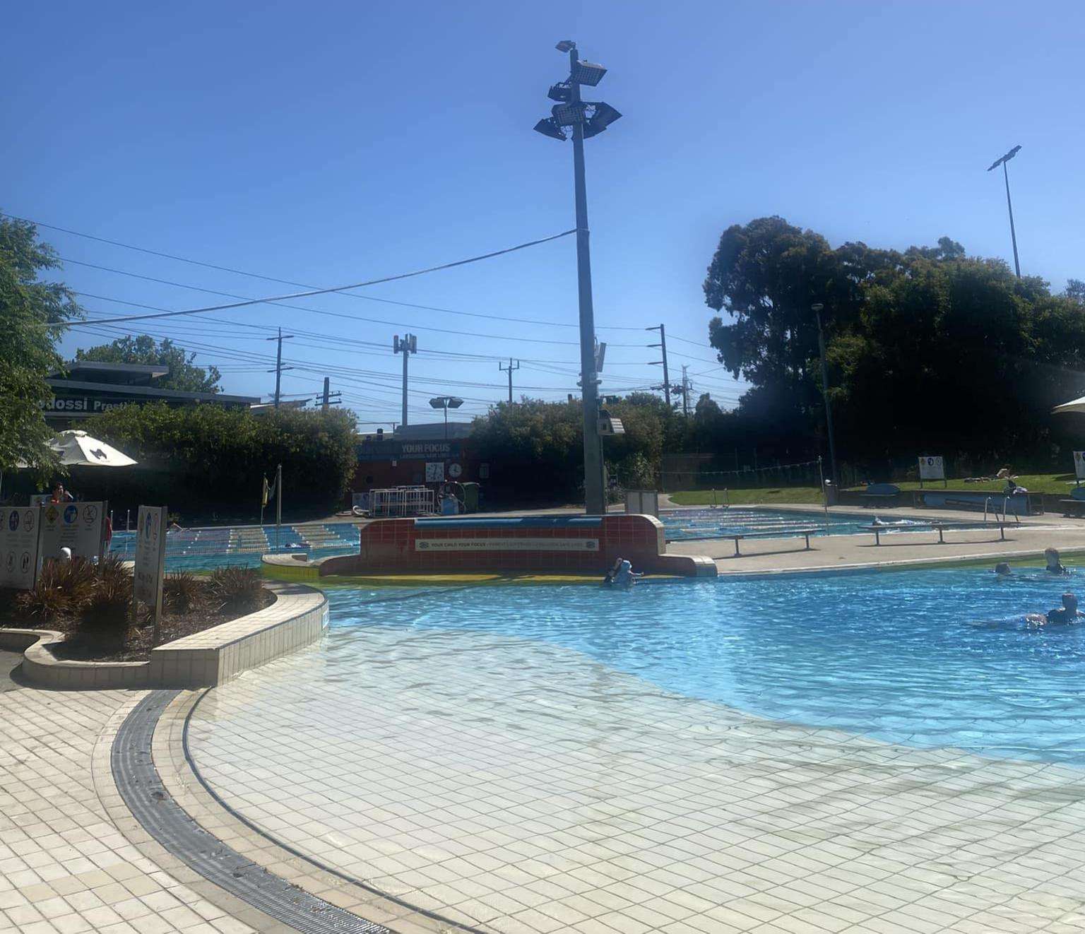 Dark grey and sea blue writing North Melbourne Recreation Centre.