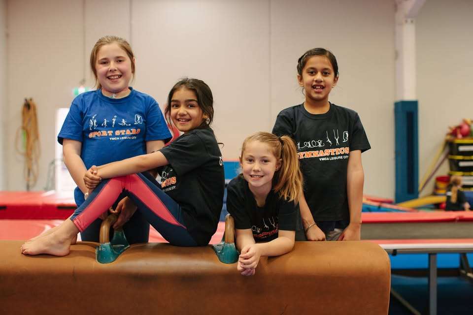 A group of children on gymnastics equipment.
